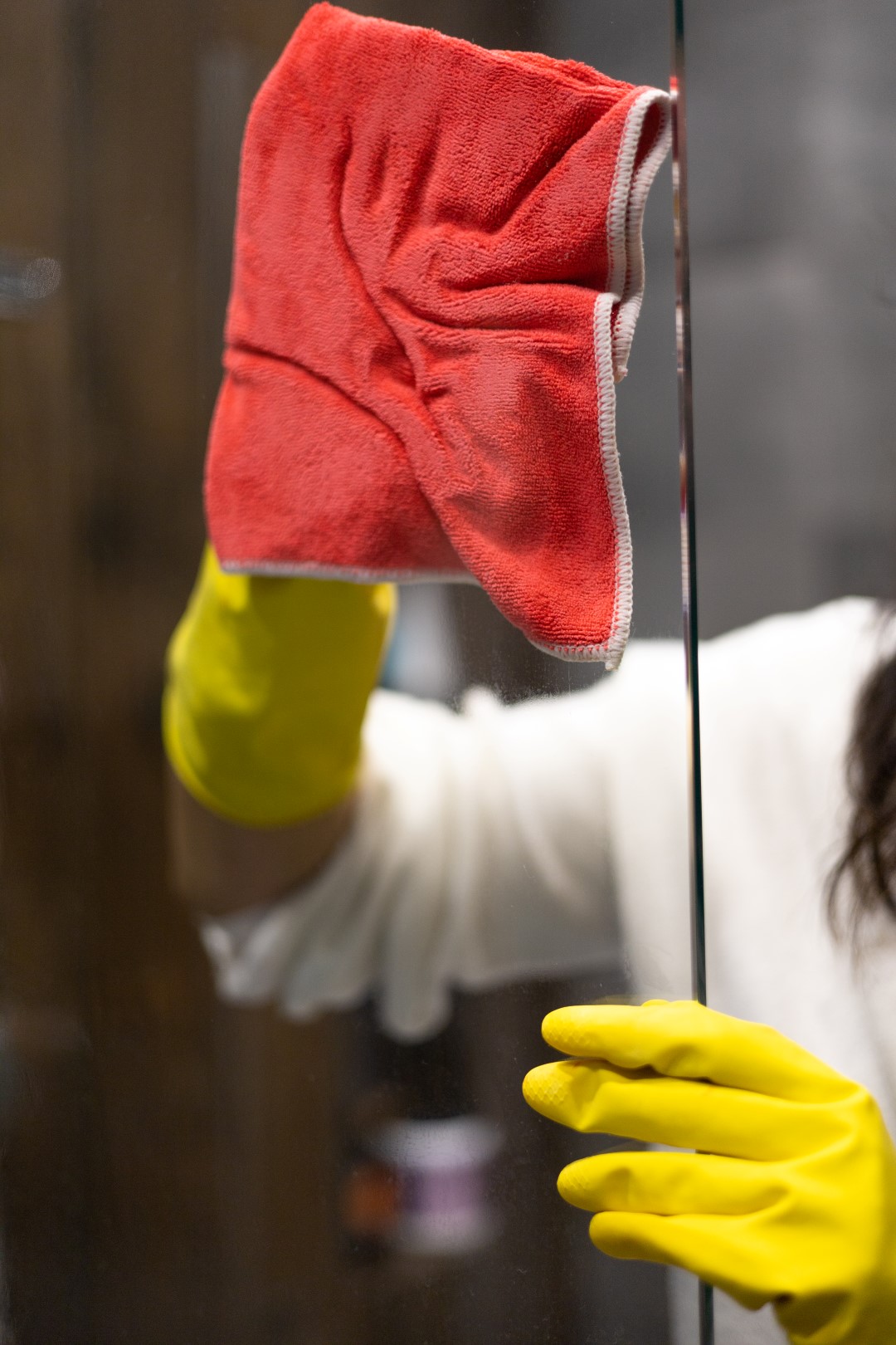 woman cleaning glass pane